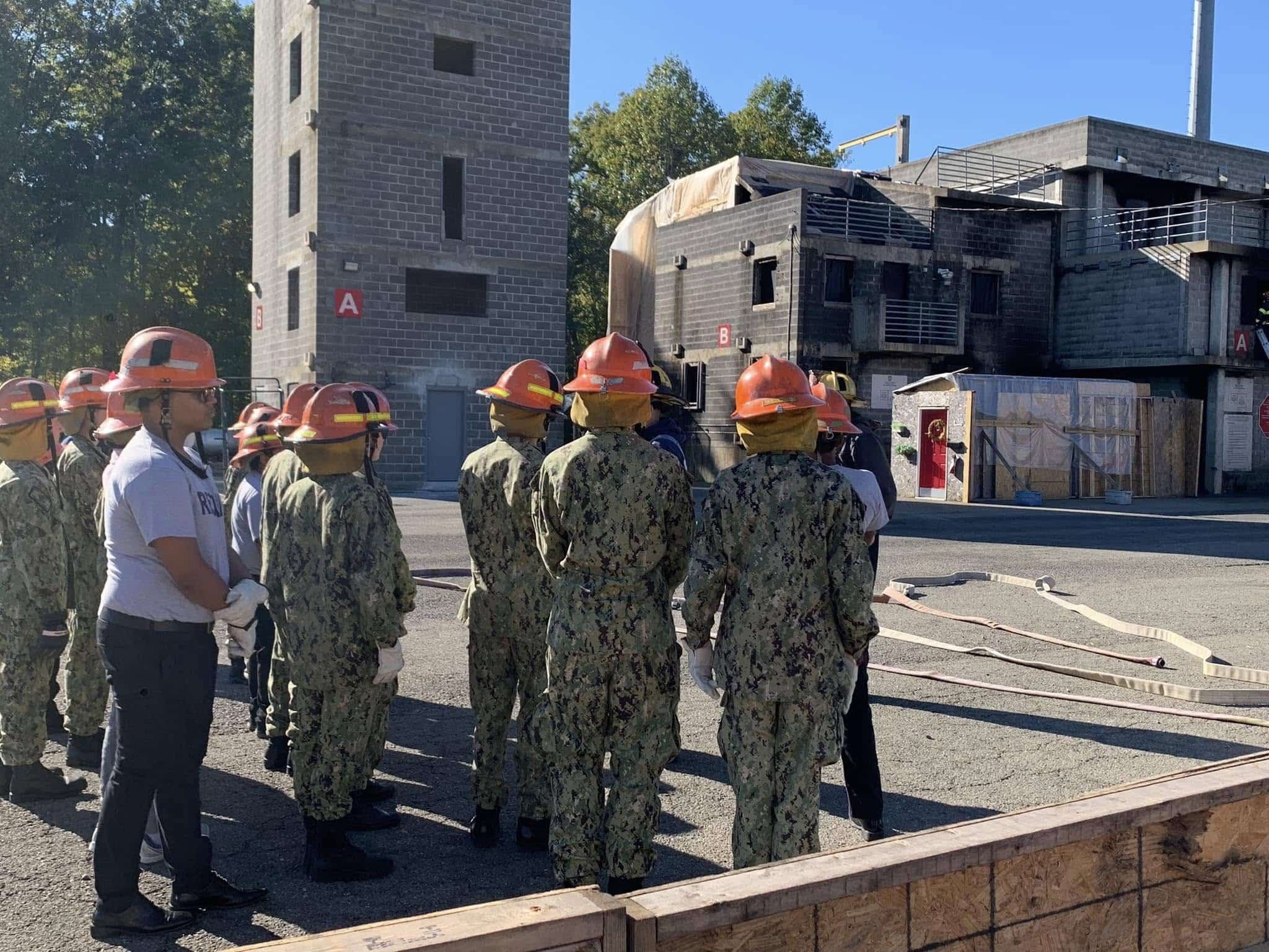 Large group of AMERICA Division cadets assembled at the burn building during firefighting training