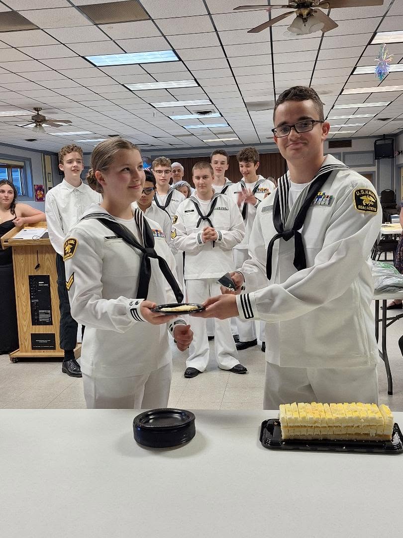 Two cadets in white dress uniforms during an awards ceremony