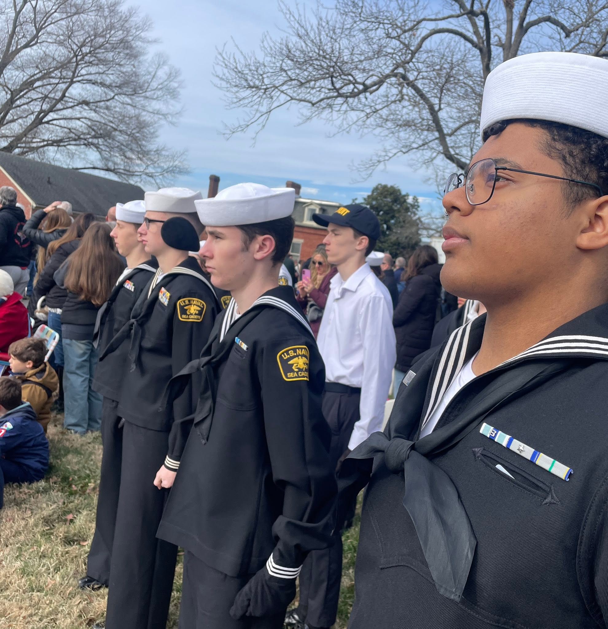 Close profile of a cadet in dress blues looking skyward
