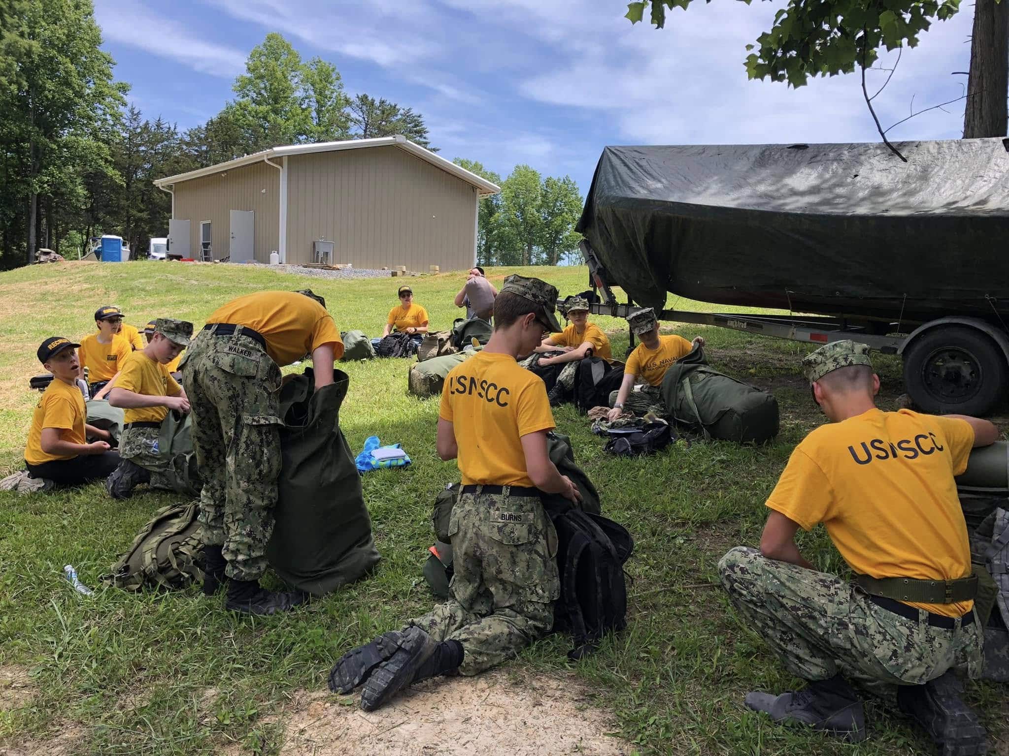 Cadets unpacking gear at an outdoor training site