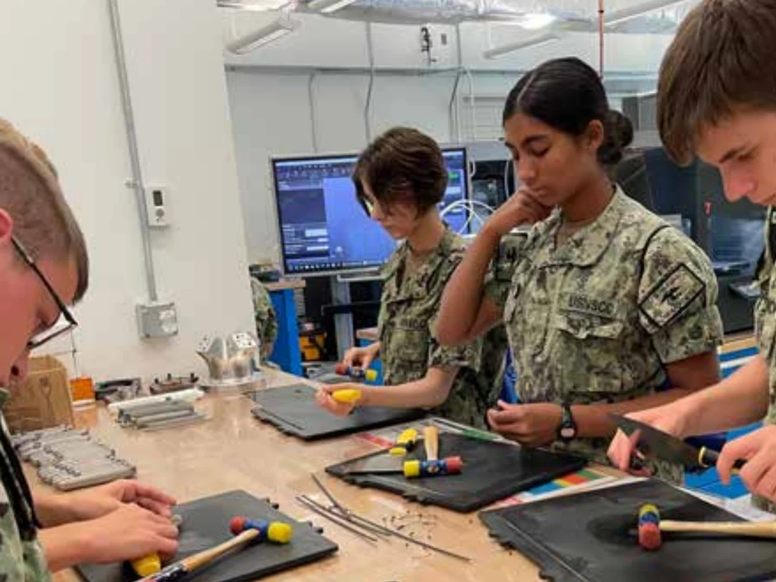 Sea Cadets working with hand tools during Maritime Industrial Arts training